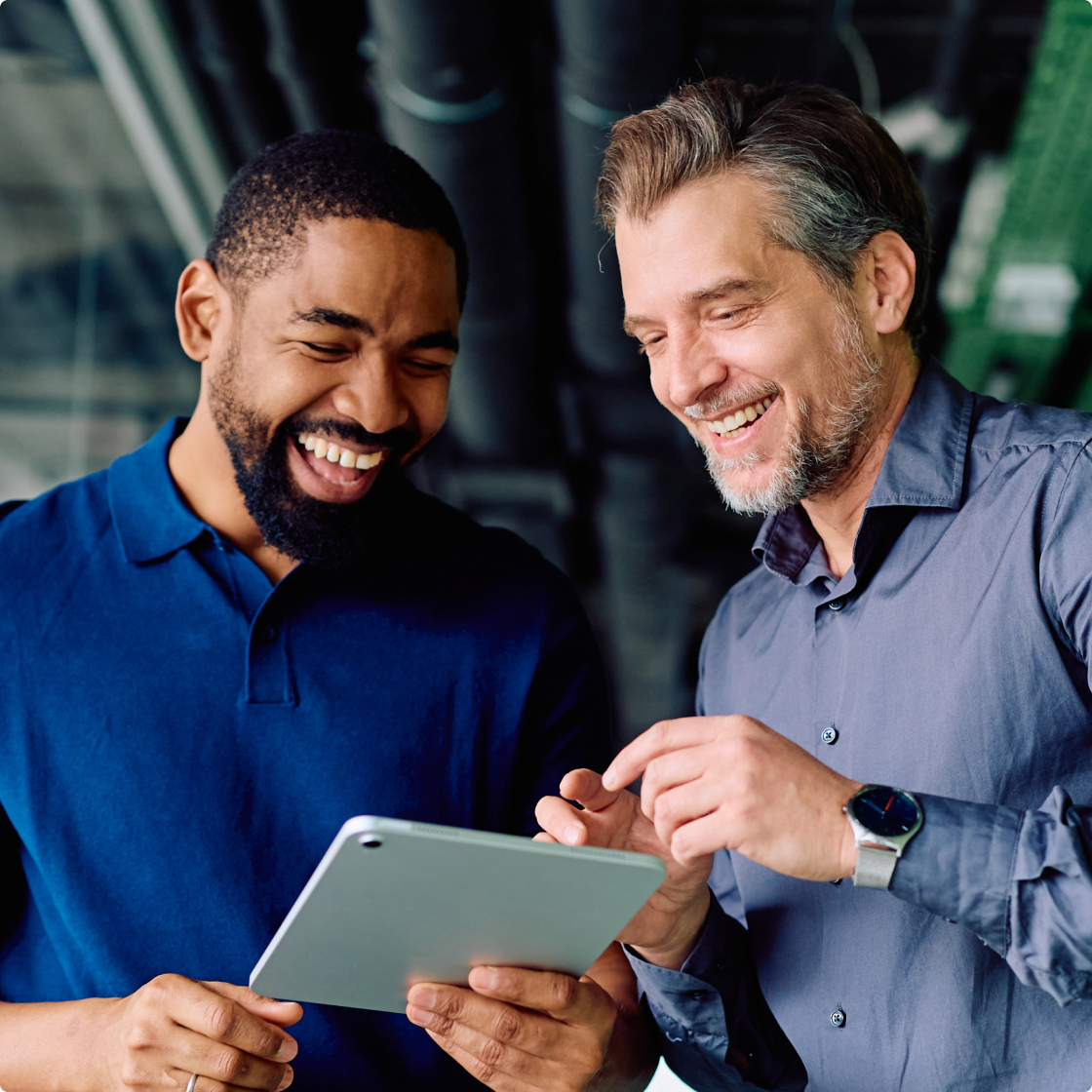 two man looking in tablet