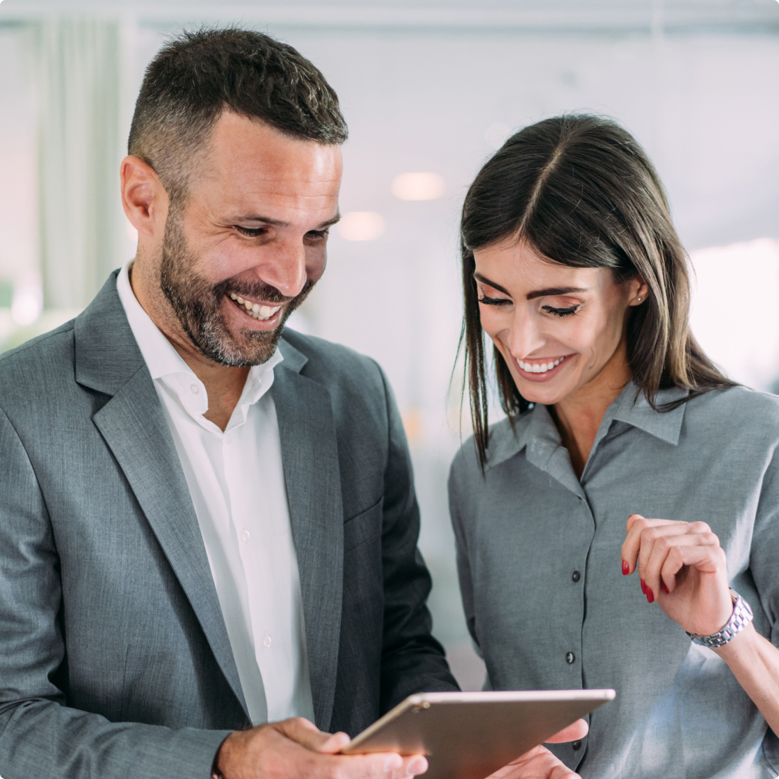 Lawyers looking at tablet in office
