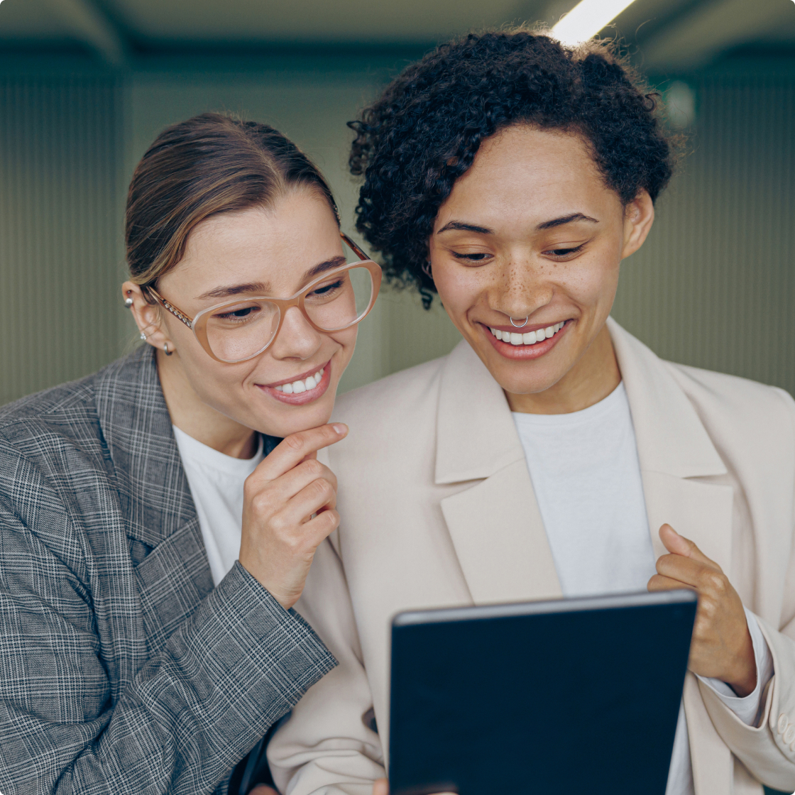 two women looking in tablet